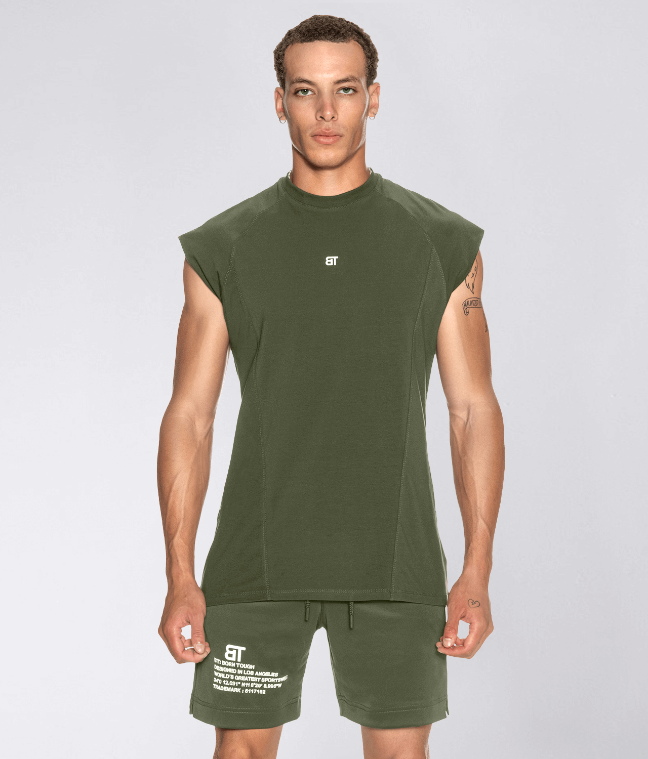 http://www.elitesports.com/cdn/shop/products/born-tough-back-shoulder-drop-sleeveless-military-green-gym-workout-shirt-for-men_1.png?v=1642692810&width=2048